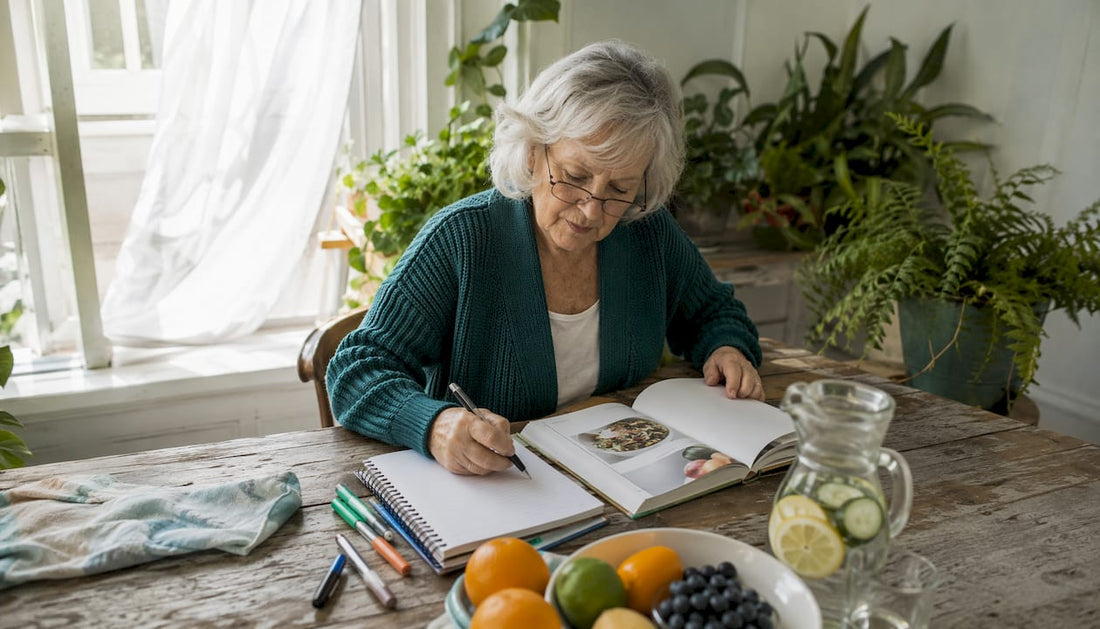 Senior woman planning diet at kitchen table
